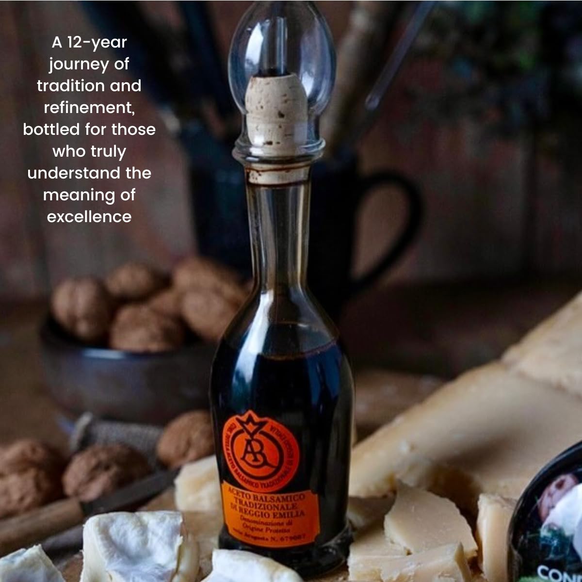 Bottle of balsamic vinegar with cheese and nuts on a wooden surface
