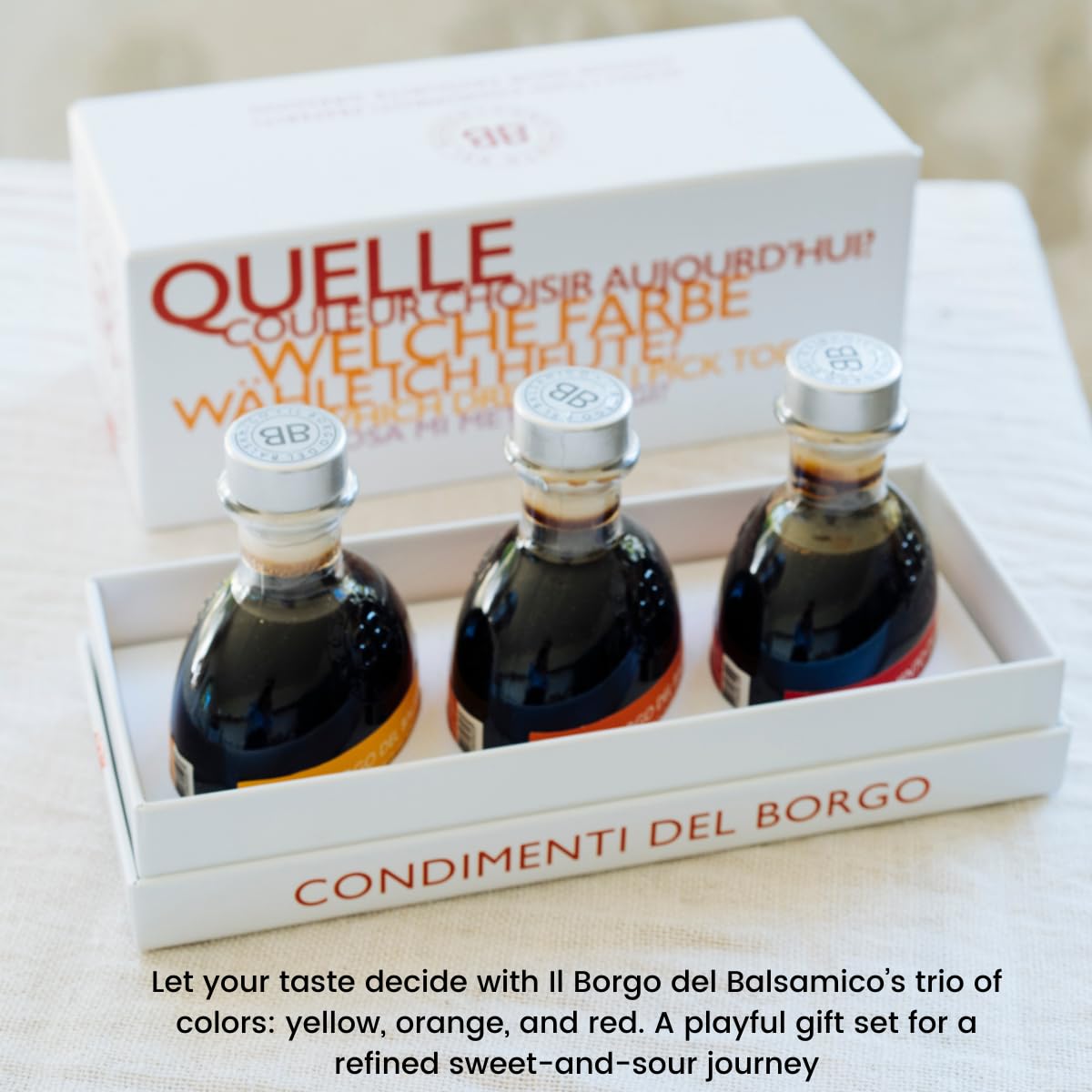 Three bottles of Balsamic vinegar in a box with 'Quelle' branding on a light background.