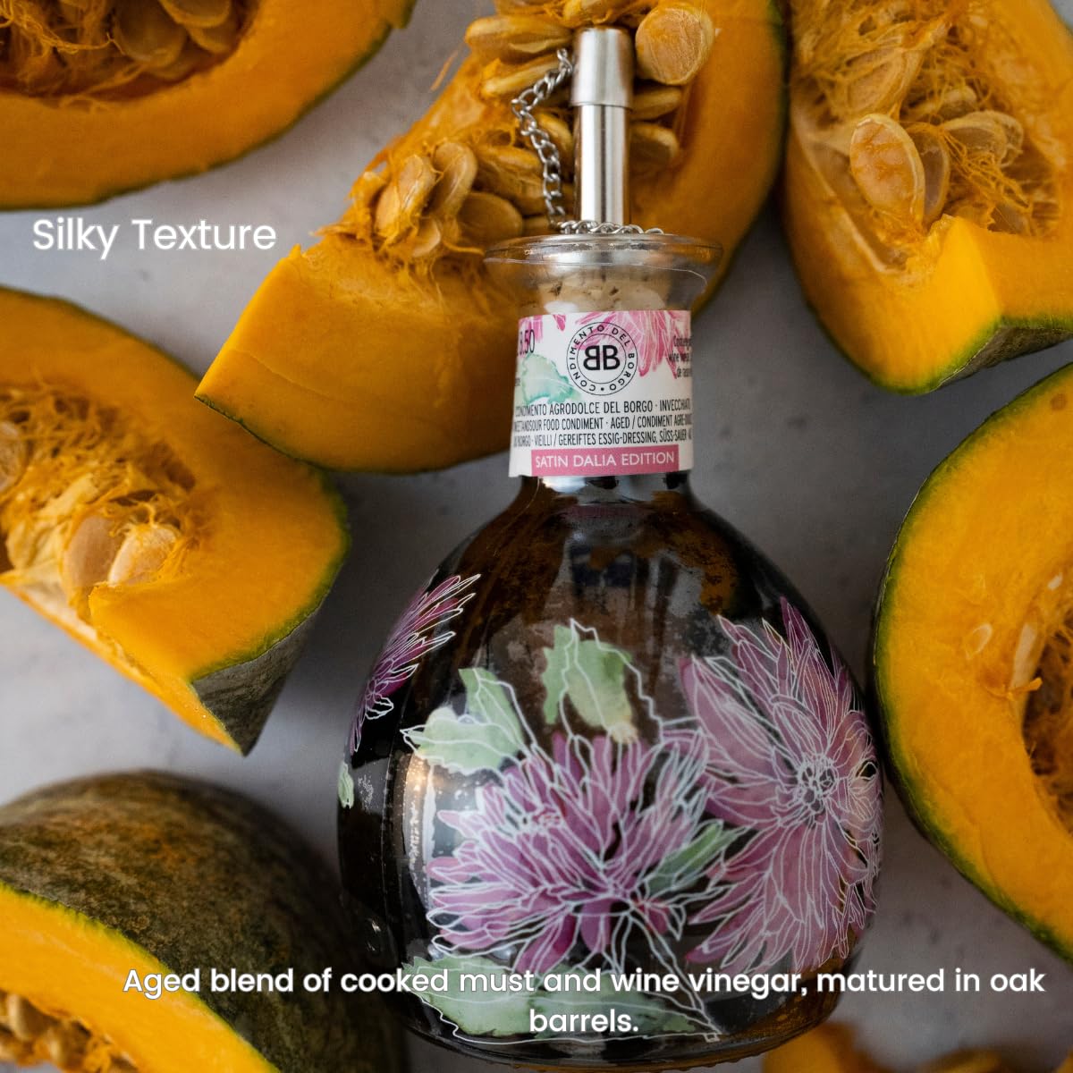 Bottle of Balsamic Vinegar with floral design surrounded by sliced pumpkins