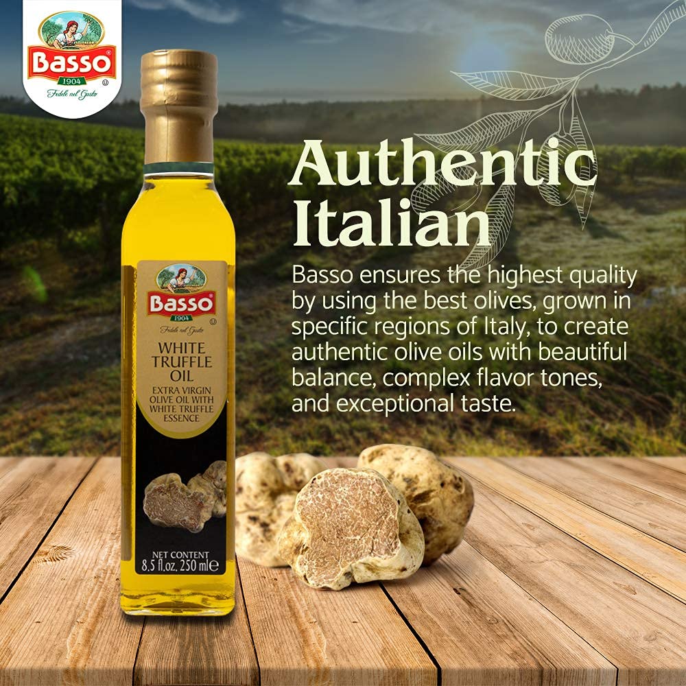 Bottle of Basso White Truffle Extra Virgin Olive Oil on wooden table with fresh white truffles, featuring text about authentic Italian quality and flavor crafted from the best olives.