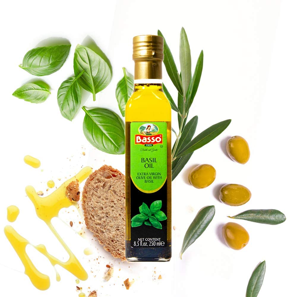 Bottle of Basso 1904 Basil Infused Extra Virgin Olive Oil, 8.5 fl oz (250 ml), placed with fresh basil leaves, olives, olive branches, bread, and a drizzle of olive oil, highlighting premium Italian quality, ideal for cooking, dipping, dressing, and Mediterranean cuisine.