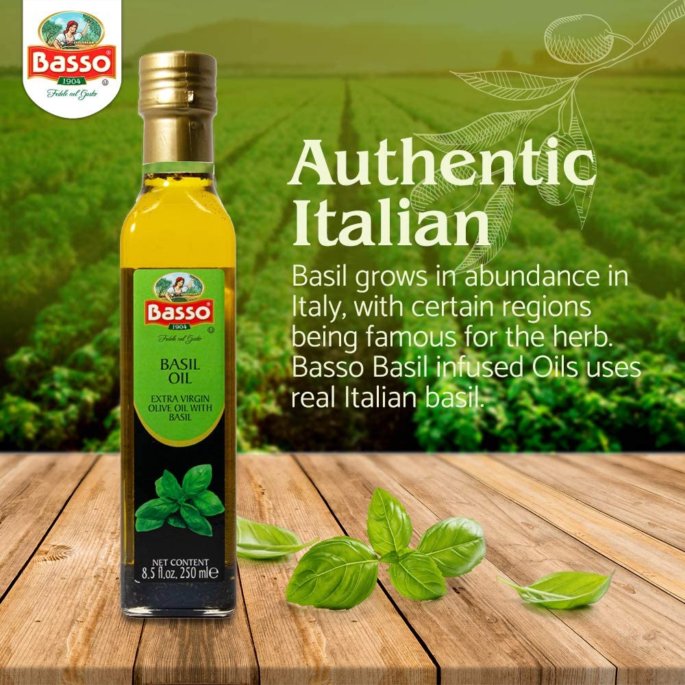Bottle of Basso 1904 Basil Infused Extra Virgin Olive Oil, 8.5 fl oz (250 ml), displayed on a wooden surface with fresh basil leaves, set against a green basil field background, emphasizing authentic Italian origin and natural basil infusion.