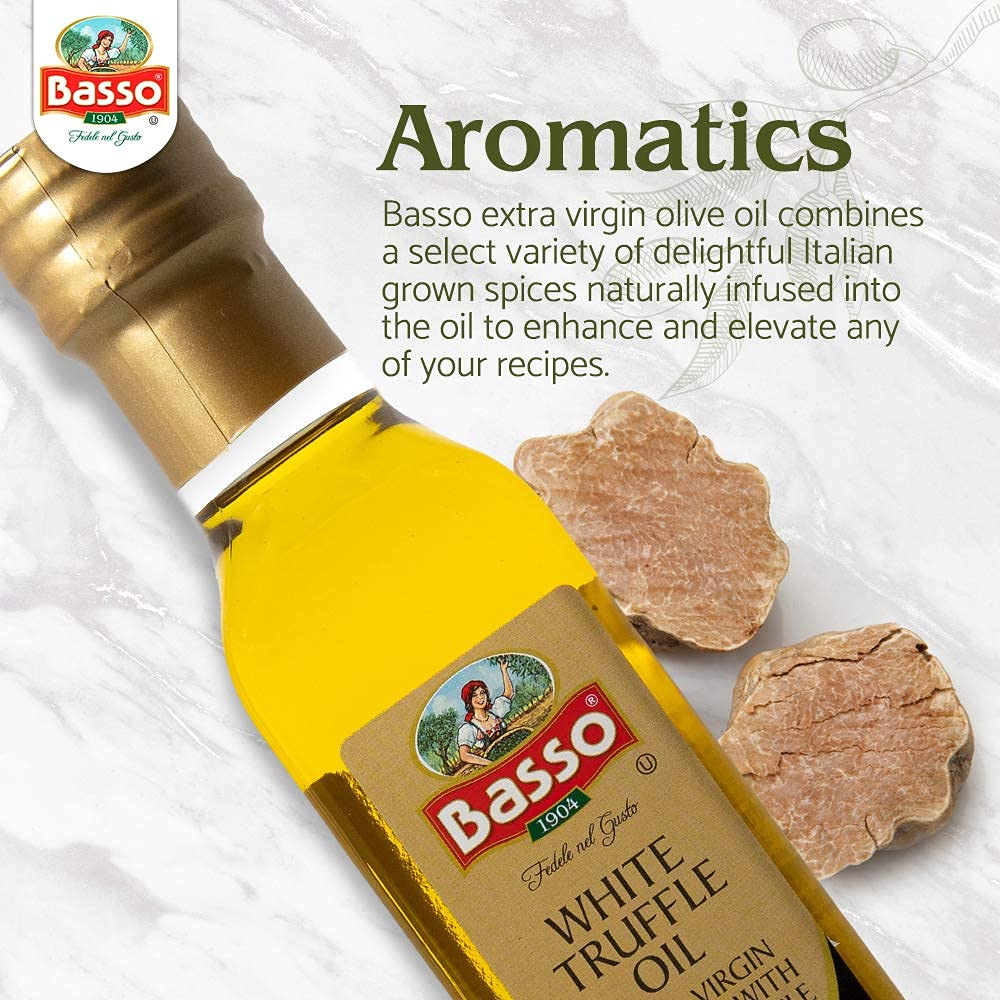 Close-up of Basso White Truffle Infused Extra Virgin Olive Oil bottle with fresh white truffle slices on marble background, highlighting aromatic Italian spices.