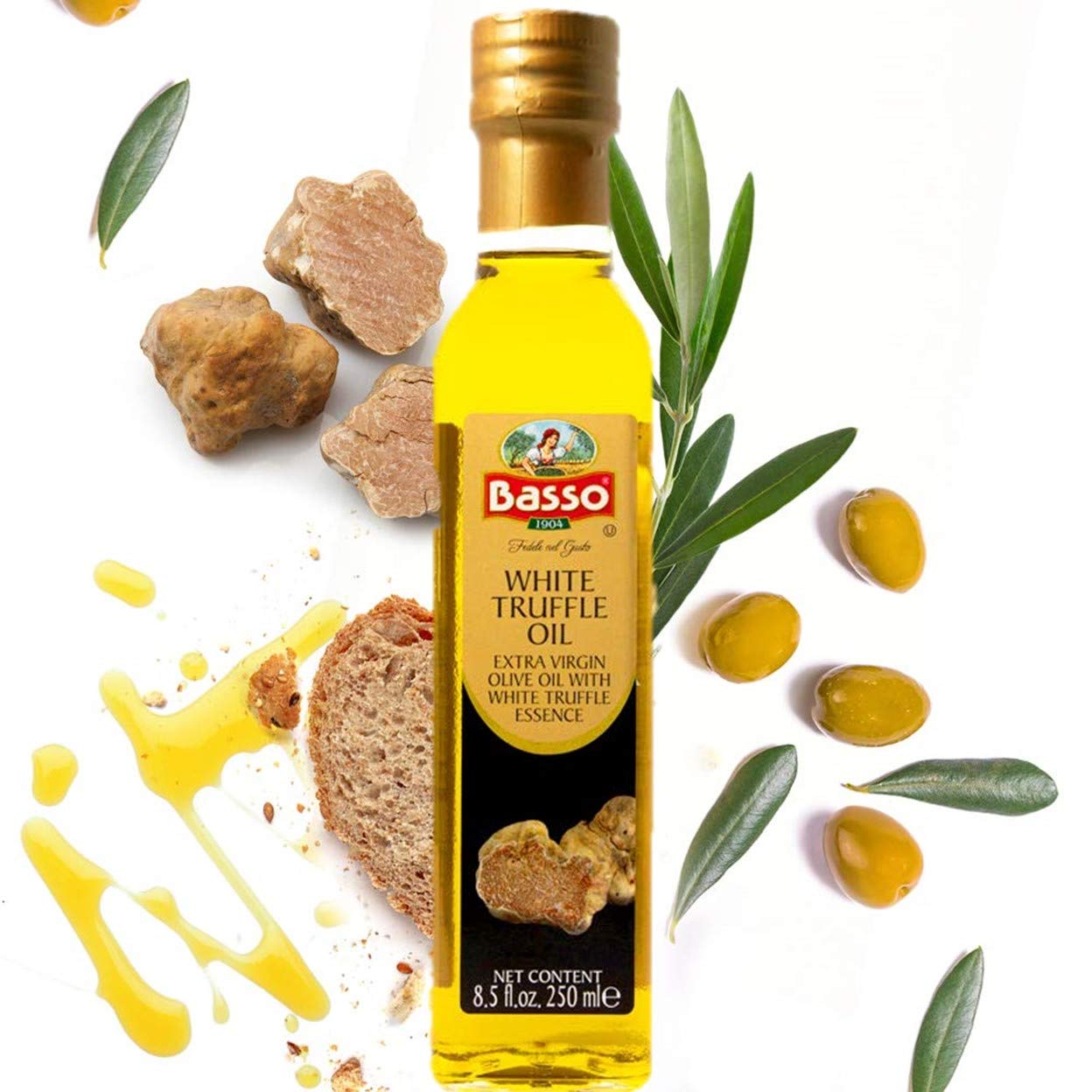 Basso White Truffle Infused Extra Virgin Olive Oil 250ml bottle with fresh truffles, olives, olive leaves, bread, and oil drizzle on white background.