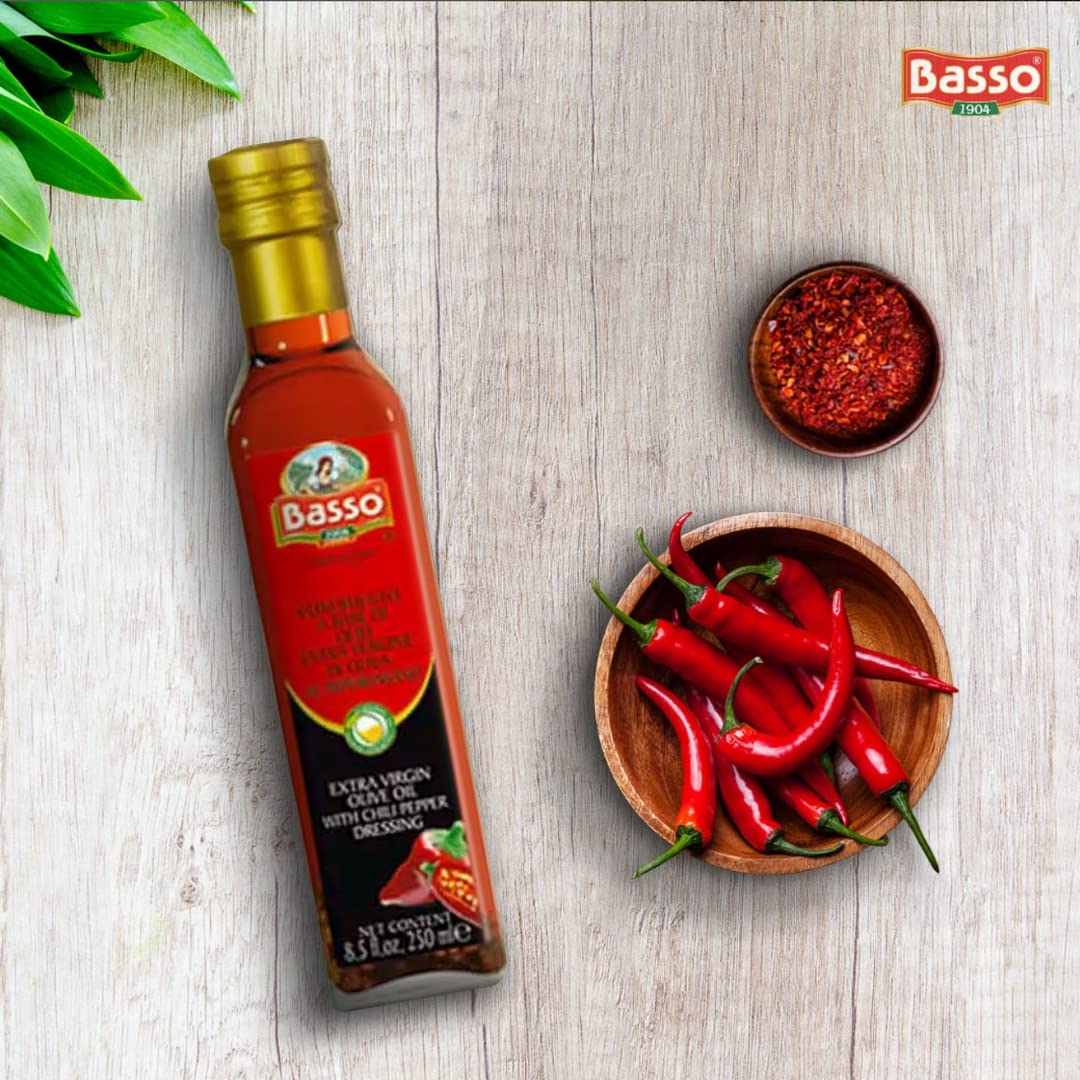 Basso olive oil bottle with red peppers and spices on a wooden surface