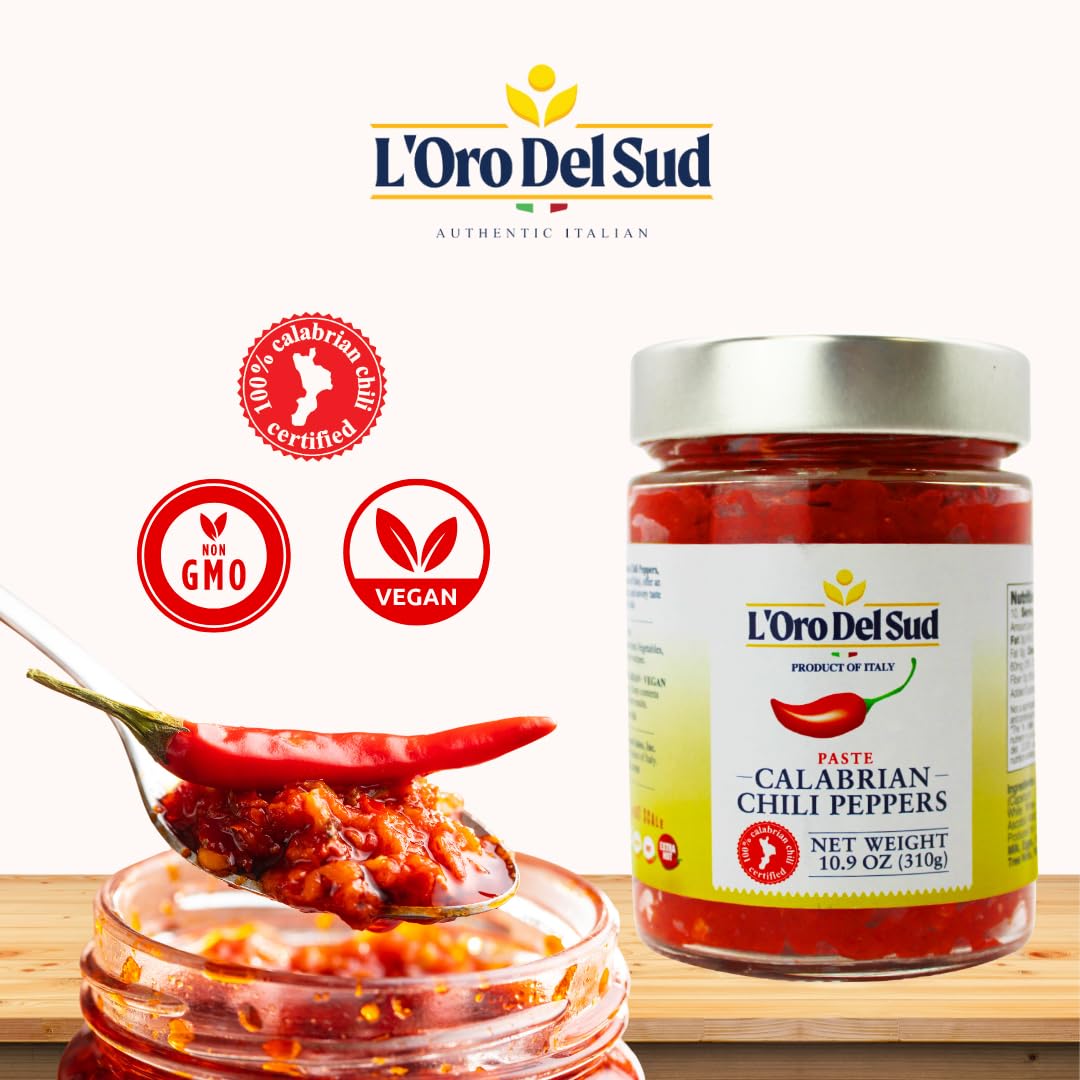 Jar of L'Oro Del Sud Calabrian Chili Peppers with a spoonful of chili paste on a white background