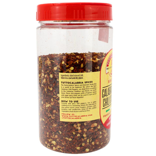 Jar of Calabrian chili peppers with a red lid on a white background
