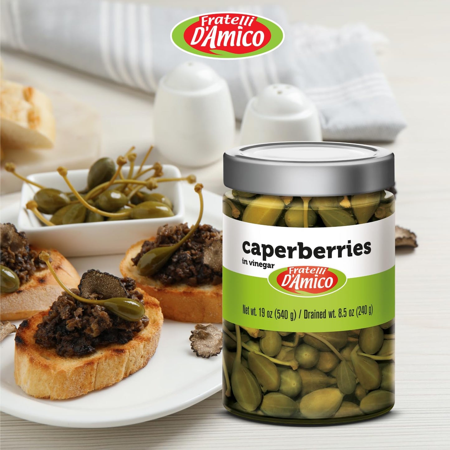 Jar of Fratelli D'Amico caperberries in vinegar, 19 oz (540 g), Italian pickled caperberries with firm texture, tangy flavor, and authentic Mediterranean quality, displayed with some caperberries served in a small dish.
