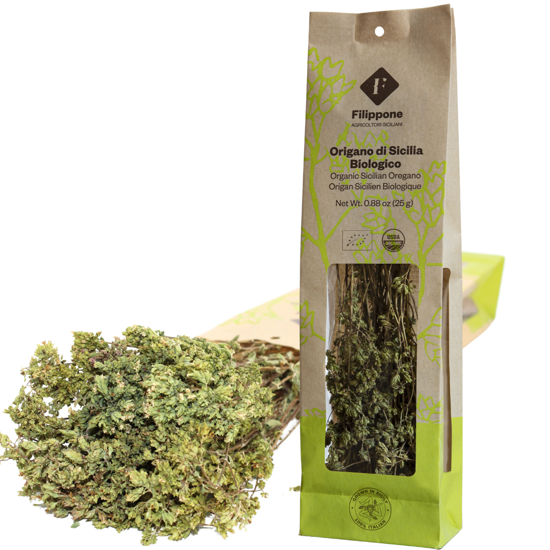 A package of Filippone Organic Oregano, showing both the product in a clear window and additional bunches of oregano leaves outside the package.