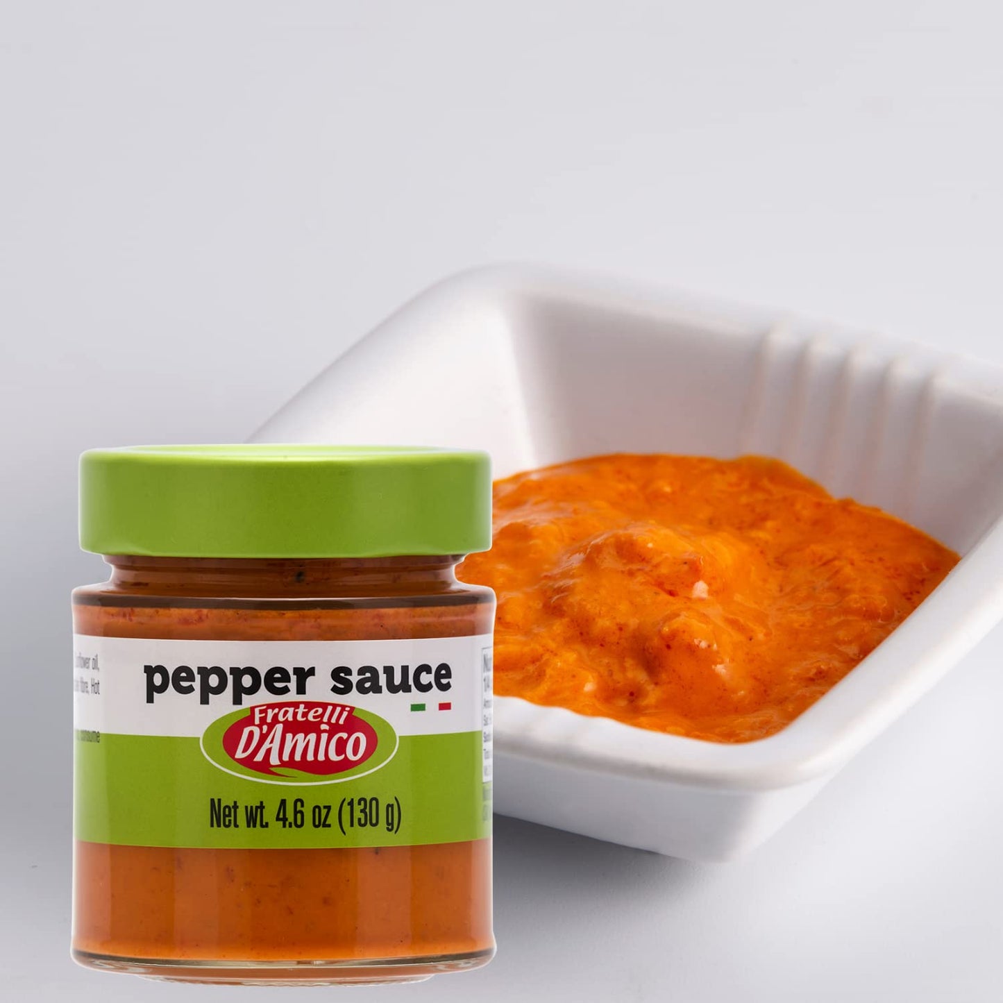 4.6 oz jar of Fratelli D'Amico Red Pepper Sauce, Italian pesto made with roasted red peppers, ideal for pasta, bruschetta, sandwiches, and meats.