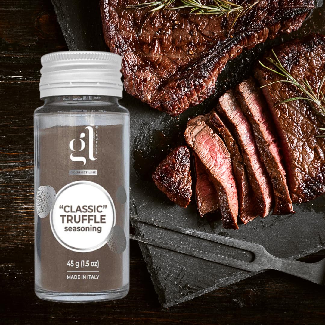 Jar of GL Classic Truffle Seasoning placed next to a sliced grilled steak on a slate board.