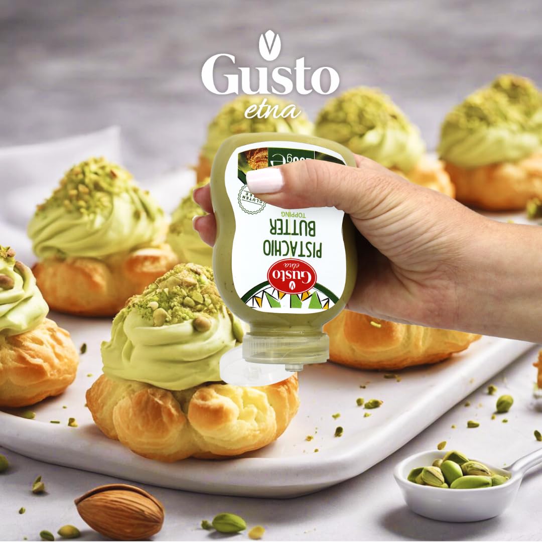 Gusto Etna pistachio butter topping bottle being squeezed onto cream puffs topped with crushed pistachios, gourmet Italian dessert decoration