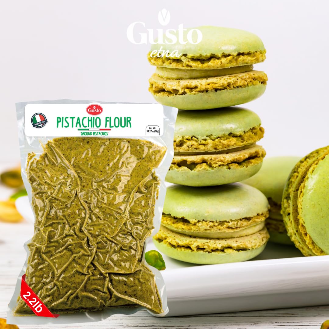 Package of Gusto Etna Pistachio Flour (2.2 lb) placed in front of a stack of green pistachio macarons with creamy filling, on a white surface, with the Gusto Etna logo displayed above