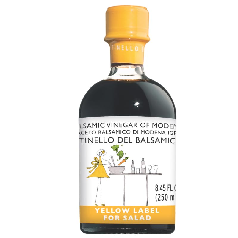 Bottle of balsamic vinegar with a yellow label on a white background