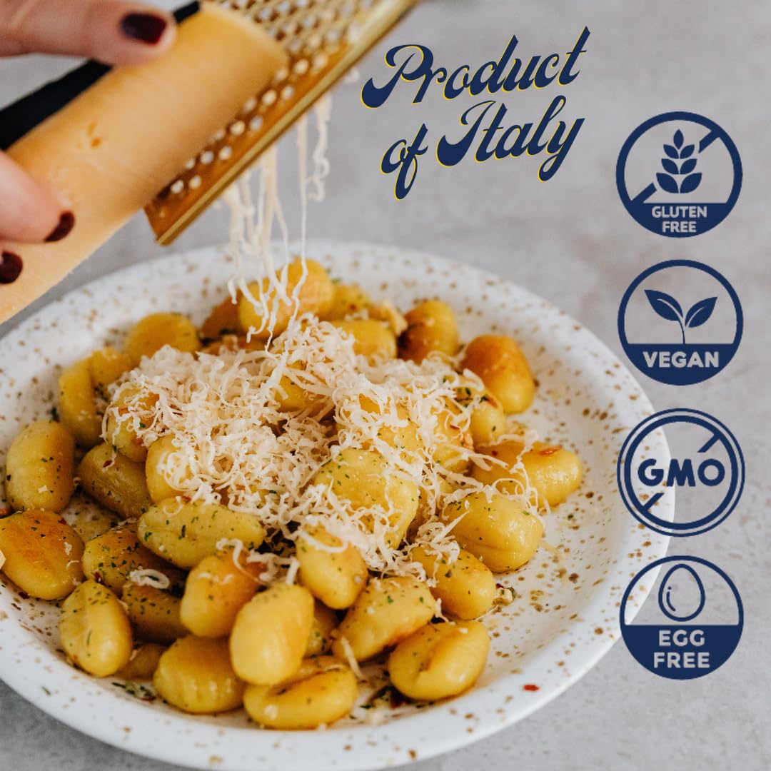Plate of golden potato gnocchi topped with grated cheese, labeled gluten free, vegan, GMO free, and egg free