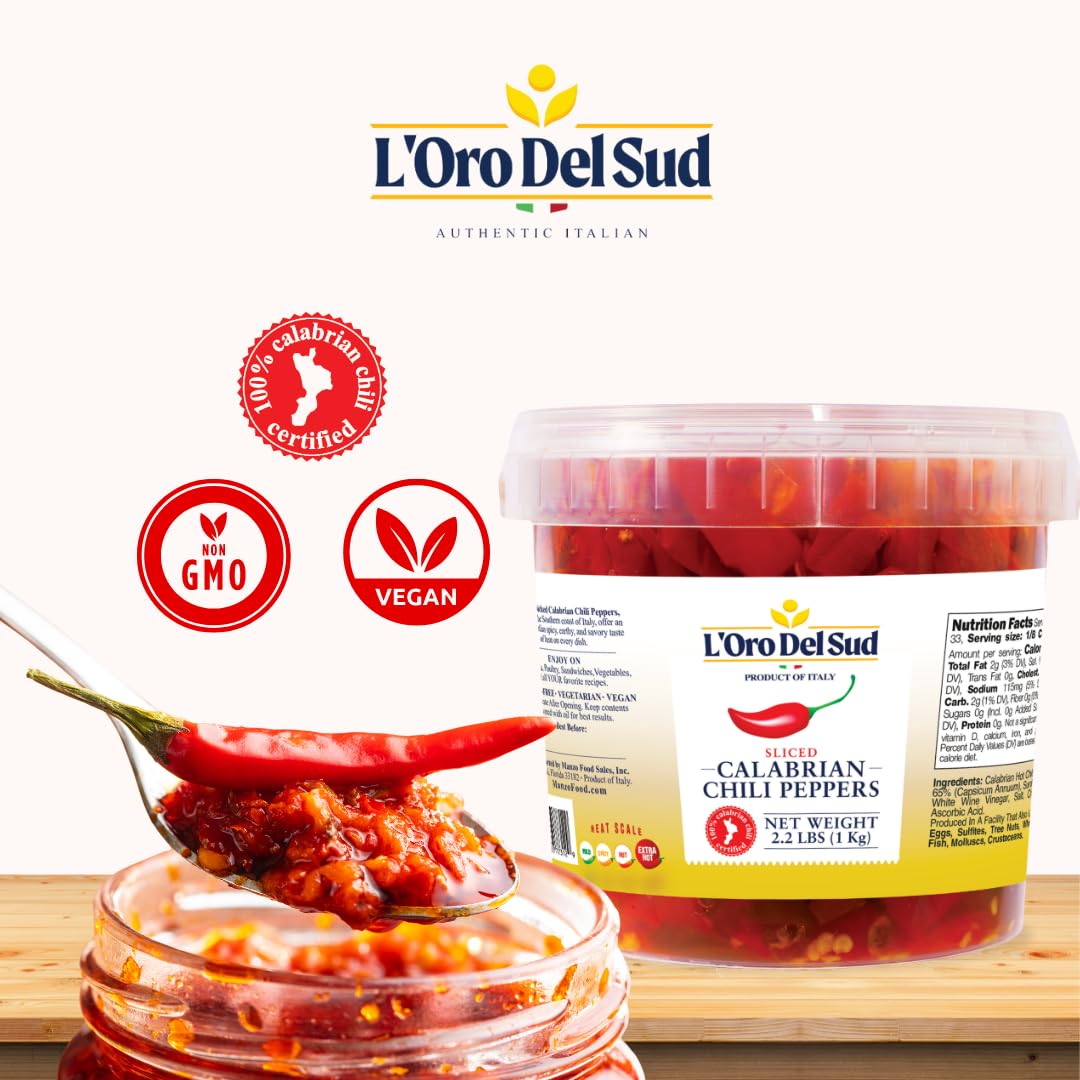 L'Oro Del Sud Calabrian chili peppers with jar and spoon on a white background