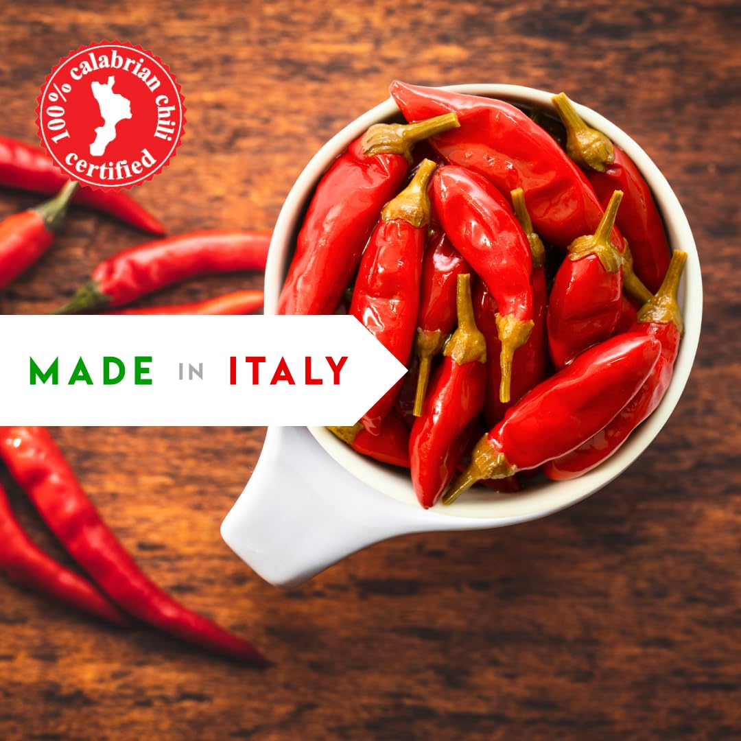 White bowl filled with red chili peppers on a wooden surface, with '100% Calabrian Chili Certified' logo and 'Made in Italy' text.