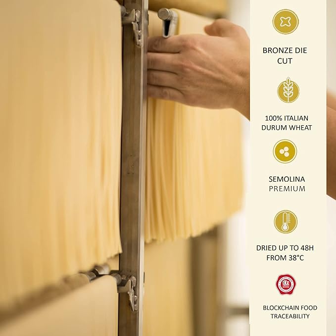 Hand arranging artisan pasta sheets drying on racks, highlighting bronze die cut, 100% Italian durum wheat, premium semolina, dried up to 48 hours at 38°C, and blockchain food traceability.