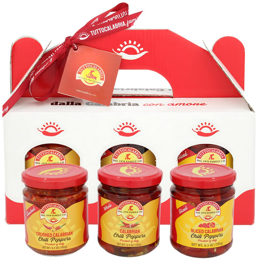 Packaging of Tutto Calabria chili pepper jars with a red ribbon and box.