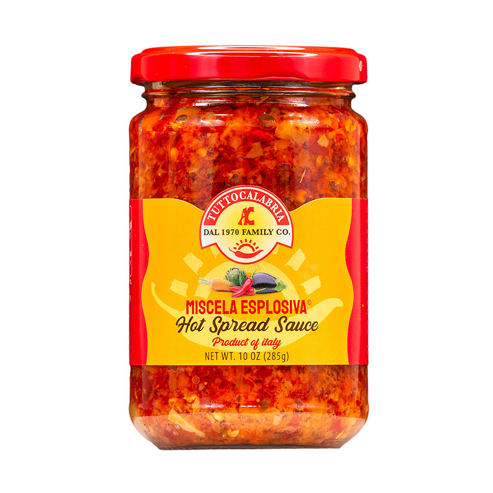 Jar of hot spread sauce with a red lid on a white background