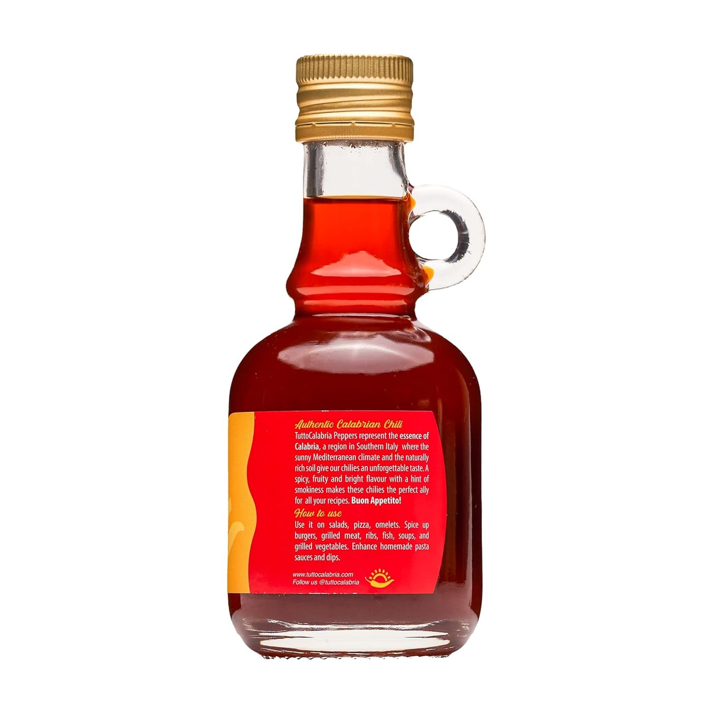 Bottle of red liquid with a gold cap on a white background