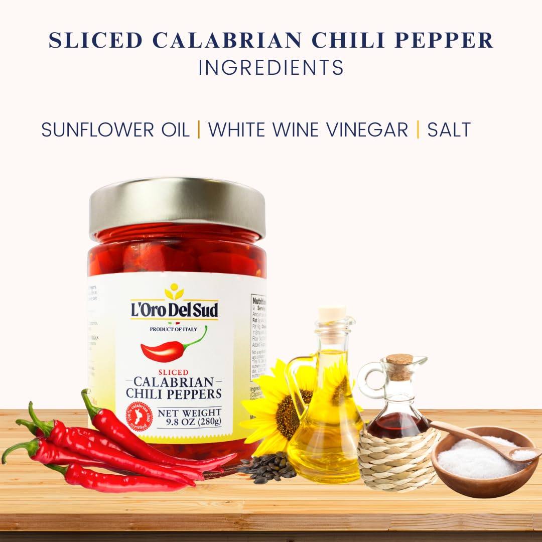 Jar of L'Oro Del Sud sliced Calabrian chili peppers with ingredients on a wooden surface.