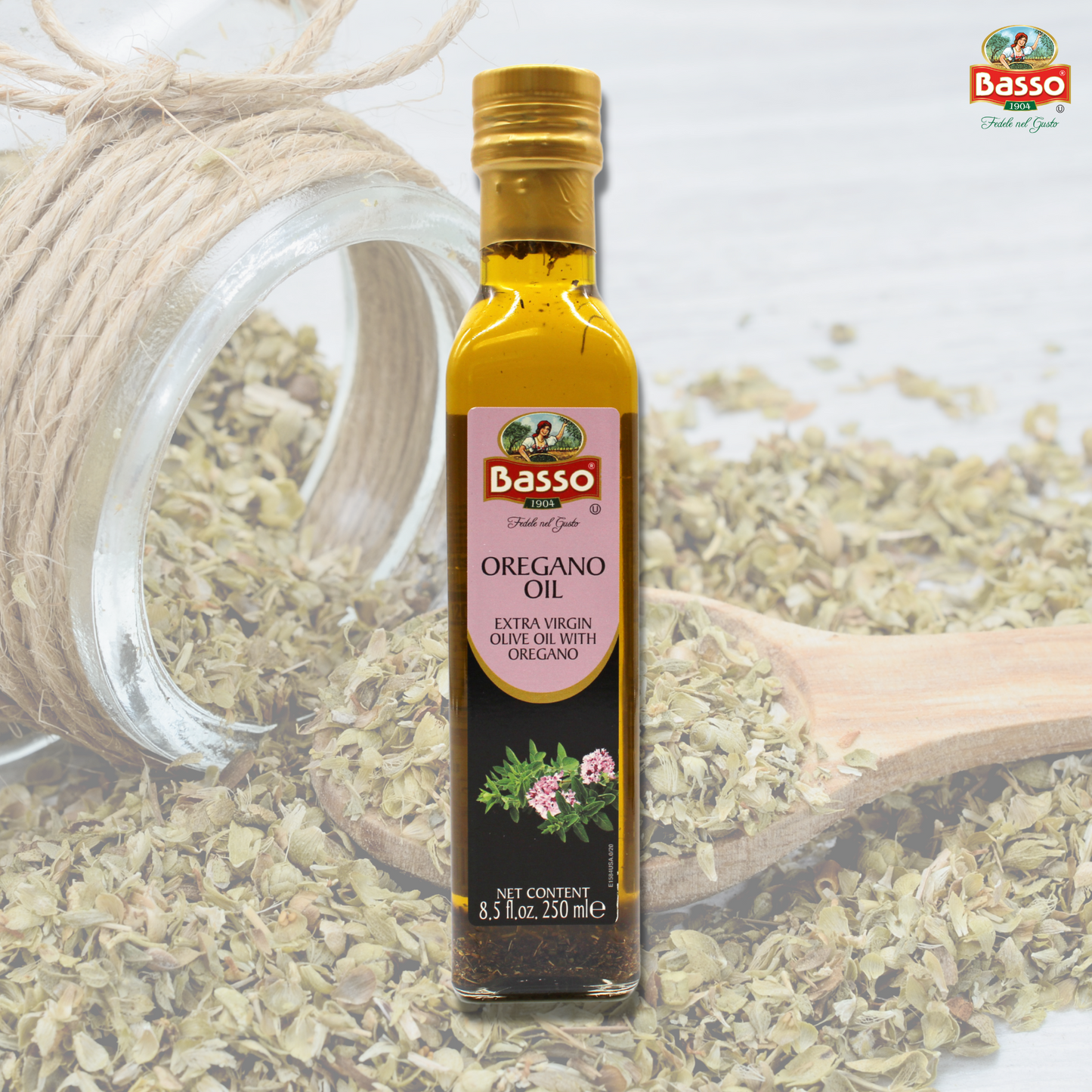Basso 1904 Oregano Infused Extra Virgin Olive Oil 8.5 fl oz (250 ml) bottle displayed with dried oregano herbs and a wooden spoon in the background.