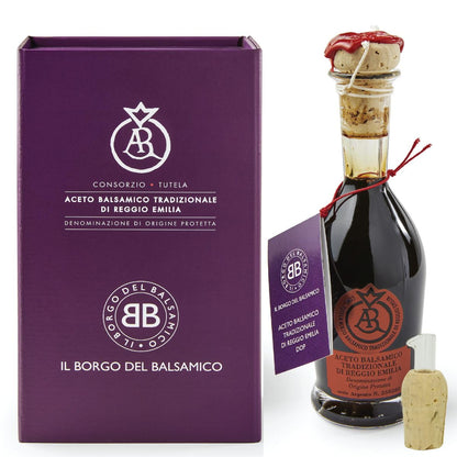Balsamic vinegar bottle with cork and packaging on a white background