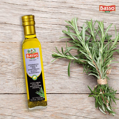 Bottle of Basso Extra Virgin Olive Oil infused with rosemary, placed on rustic wooden background with fresh rosemary sprigs.