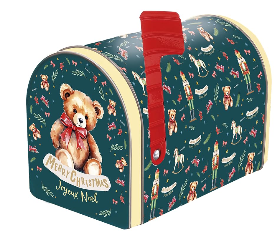 A decorative holiday mailbox featuring a dark teal background with a Christmas nutcracker and teddy bear pattern, a large illustration of a teddy bear wearing a red bow on the front, and a bright red flag.