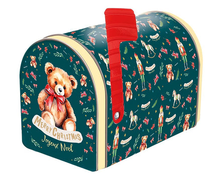 A decorative holiday mailbox featuring a dark teal background with a Christmas nutcracker and teddy bear pattern, a large illustration of a teddy bear wearing a red bow on the front, and a bright red flag.