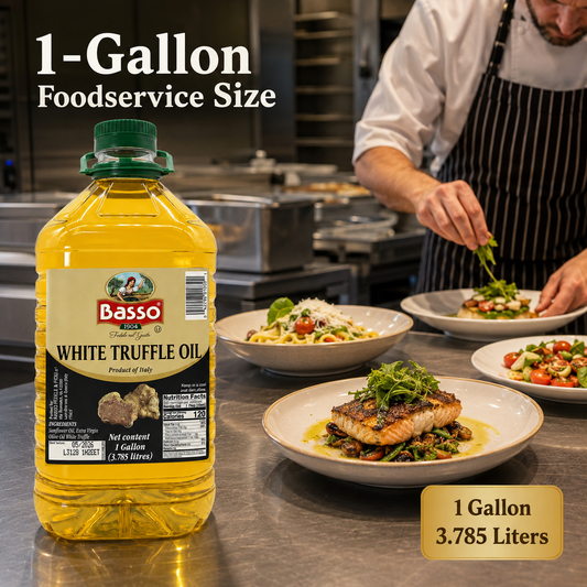 A 1-gallon bottle of Basso White Truffle Oil is shown in a professional kitchen setting next to plated cooked food, with text overlays indicating '1-Gallon Foodservice Size' and '1 Gallon 3.785 Liters'.
