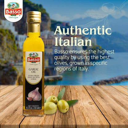 Basso 1904 Garlic Infused Extra Virgin Olive Oil 8.5 fl oz (250 ml) bottle on a wooden table with fresh olives, set against an Italian coastal backdrop, highlighting its authentic Italian origin and quality.