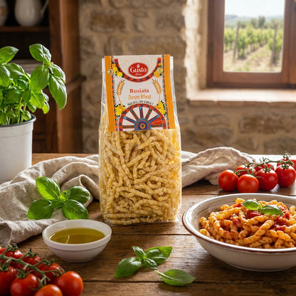 Pasta package with a bowl of pasta and fresh ingredients on a wooden table.