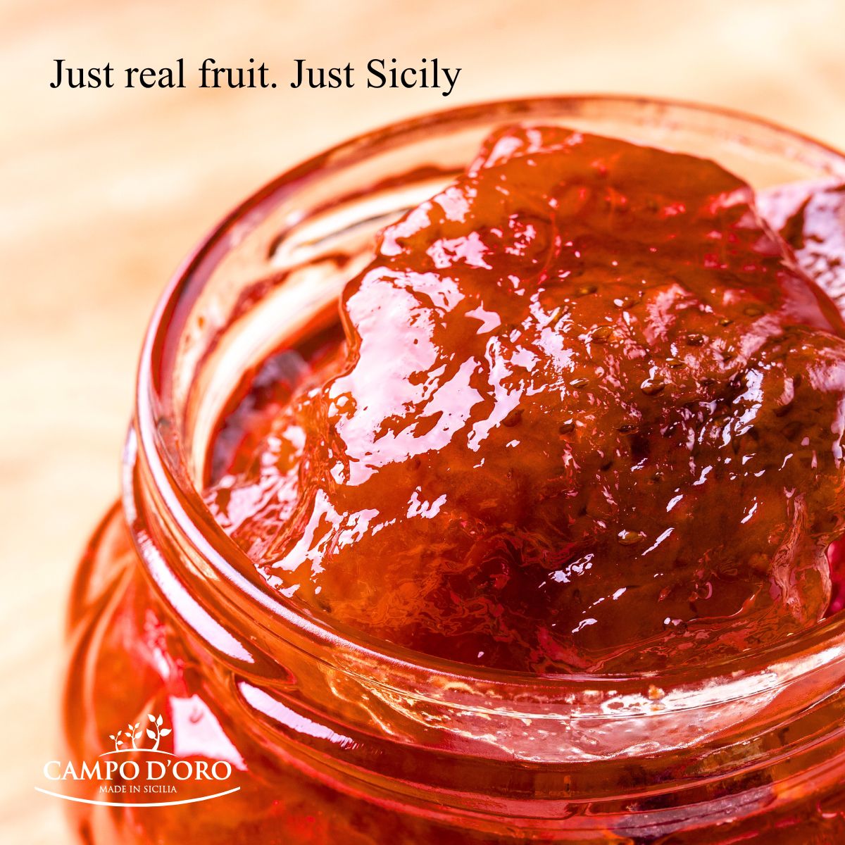 Jar of red fruit preserve with 'Campo d'Oro' branding and text 'Just real fruit. Just Sicily'.