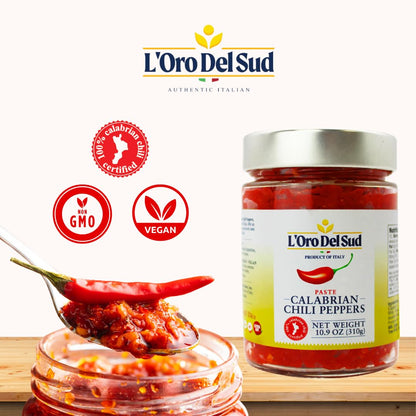 Jar of L'Oro Del Sud Calabrian Chili Peppers with a spoonful of chili paste on a white background