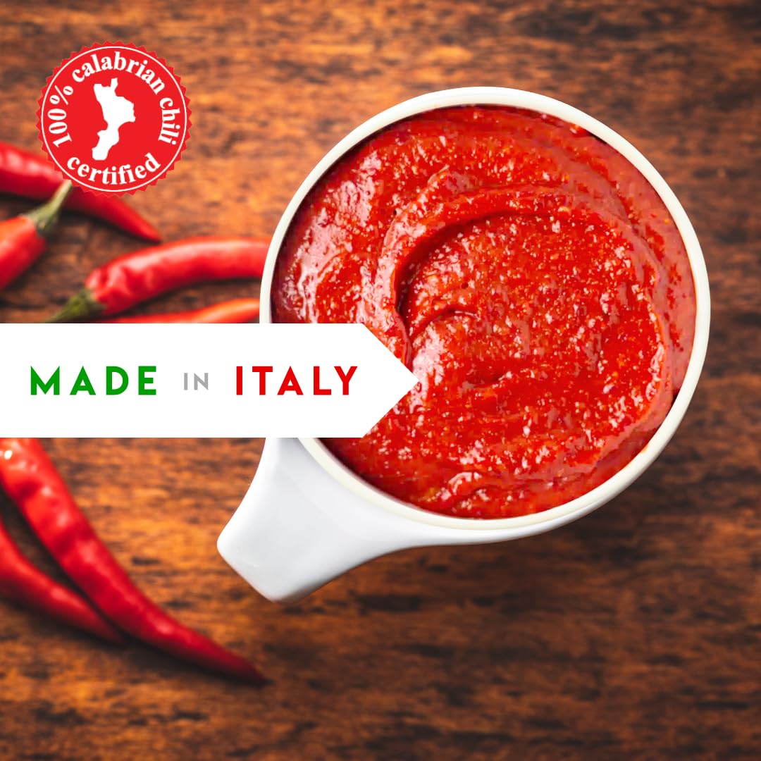 Red sauce in a white container with red chili peppers on a wooden background, featuring '100% Calabrian Chili Certified' and 'Made in Italy' text.