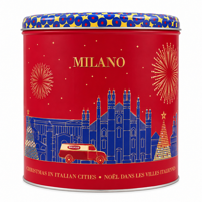 A round red metal tin with a patterned lid, featuring blue and gold illustrations of Milan landmarks, fireworks, a red Vespa, and the text 'MILANO' and 'CHRISTMAS IN ITALIAN CITIES • NOÈL DANS LES VILLES ITALIENNES'.