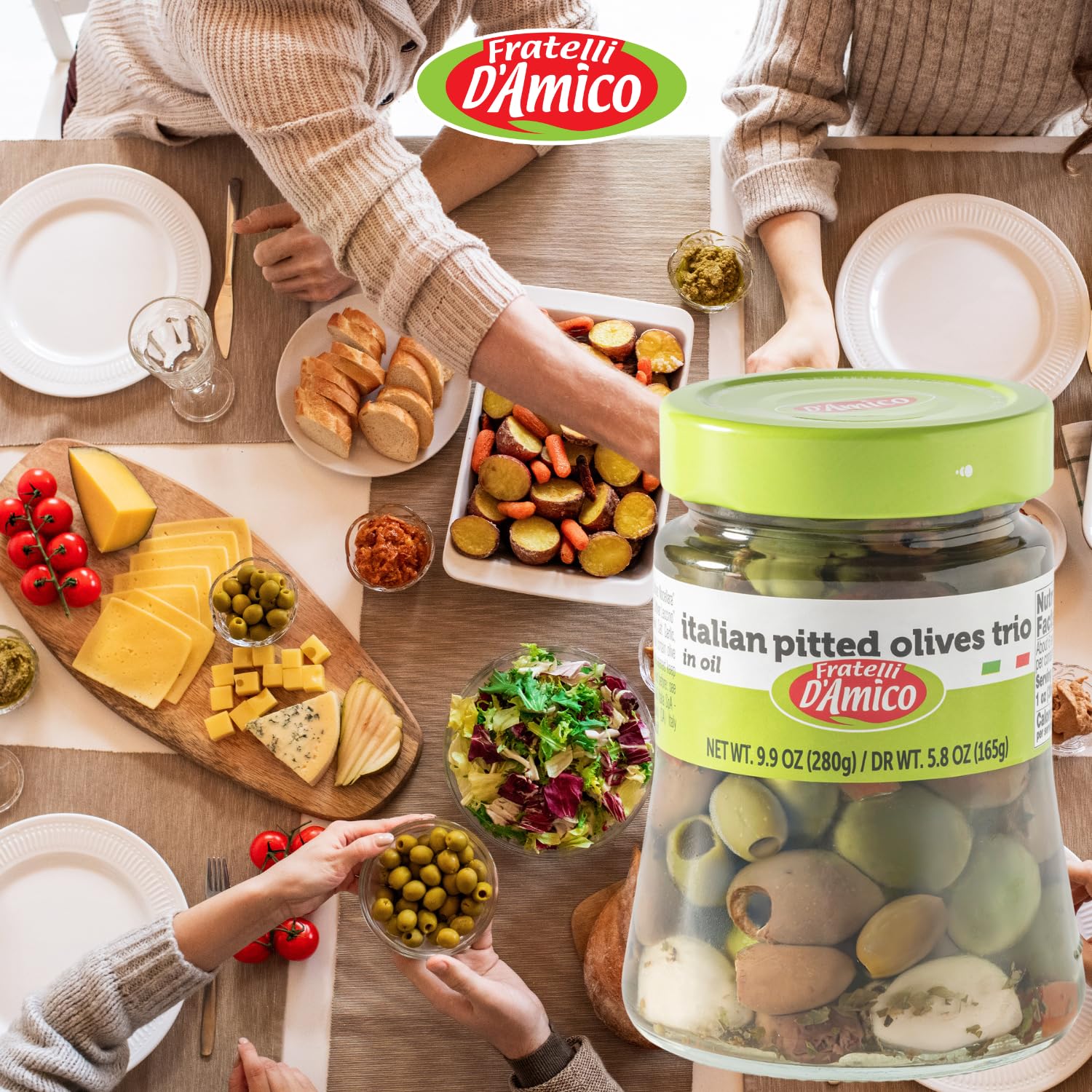 Jar of Fratelli D’Amico Italian Pitted Olives Trio in oil displayed on a table with bread, cheese, salad, and appetizers, perfect for Mediterranean meals