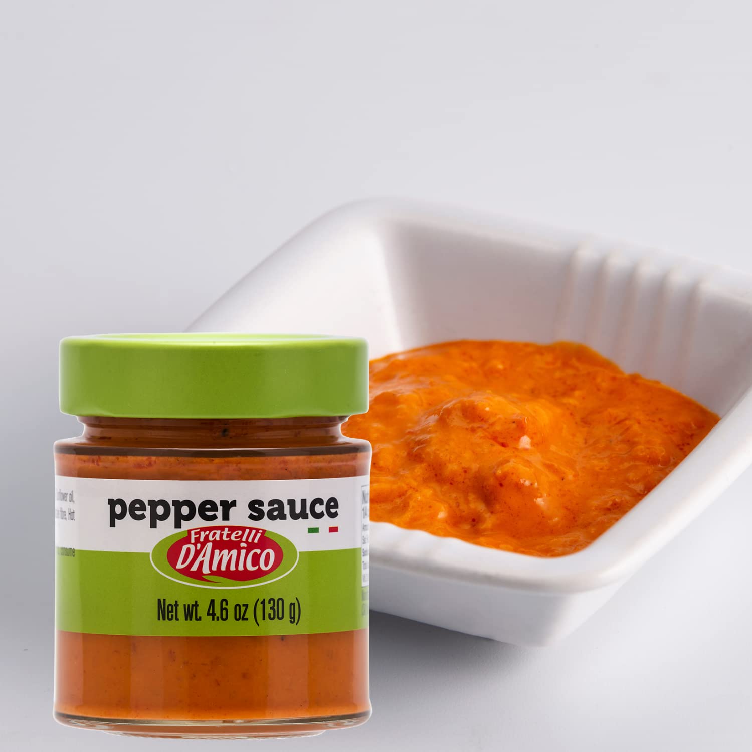 4.6 oz jar of Fratelli D'Amico Red Pepper Sauce, Italian pesto made with roasted red peppers, ideal for pasta, bruschetta, sandwiches, and meats.