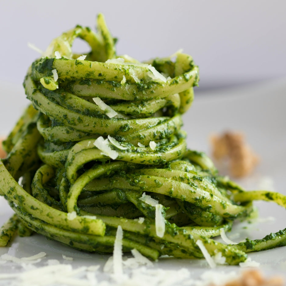 Italian pasta with pistachio pesto sauce and grated cheese
