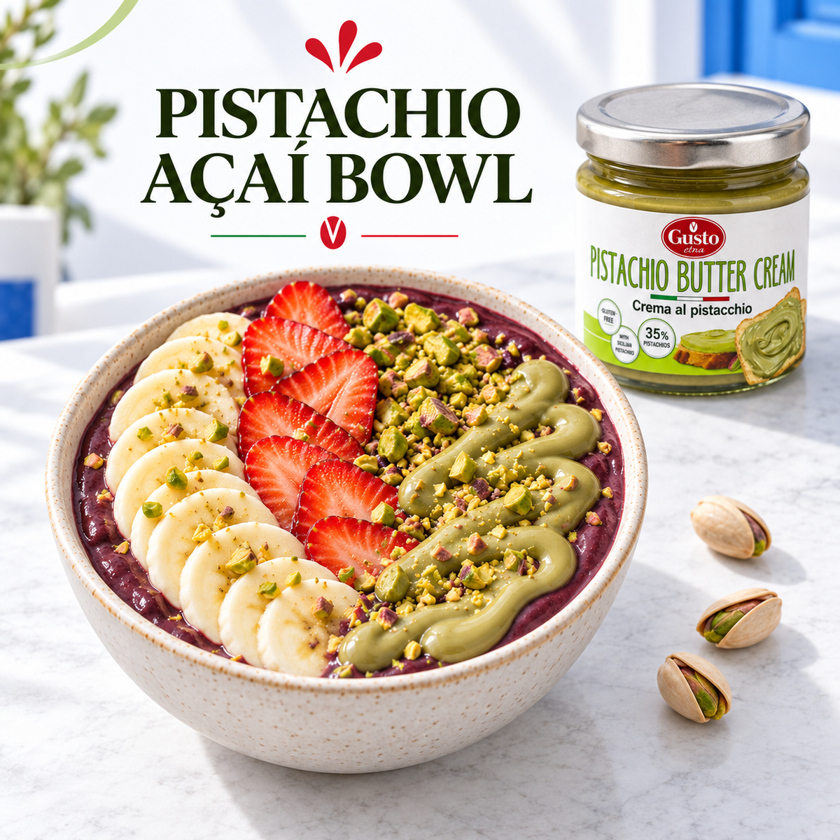 A bowl of pistachio açaí smoothie topped with banana slices, strawberries, chopped pistachios, and a green drizzle, shown next to a jar of Guisio Pistachio Butter Cream on a light marble surface.