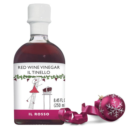 Bottle of red wine vinegar with a decorative pink ornament on a white background