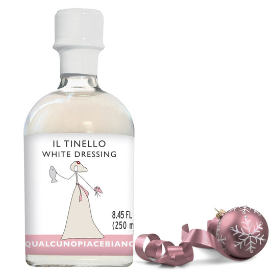 Bottle of Il Tinello White Dressing with a decorative pink ornament on a white background