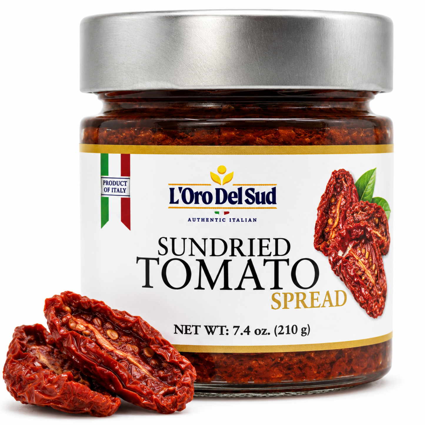 A jar of L'Oro Del Sud Sundried Tomato Spread with a silver lid and white label, shown on a white background with dried tomato slices in front.