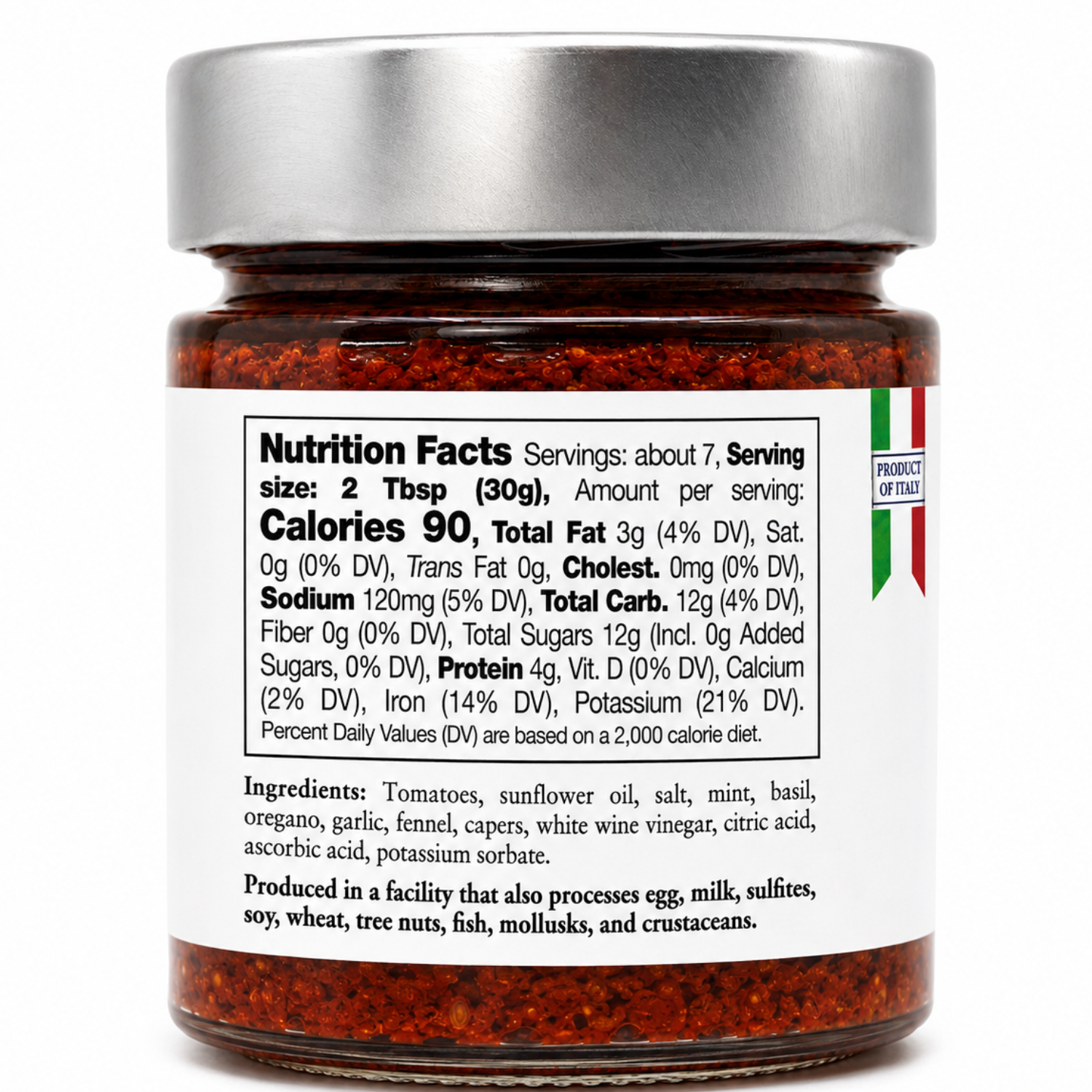 A jar of red pepper flakes with a silver lid and a white nutrition facts label, photographed on a clean white background.
