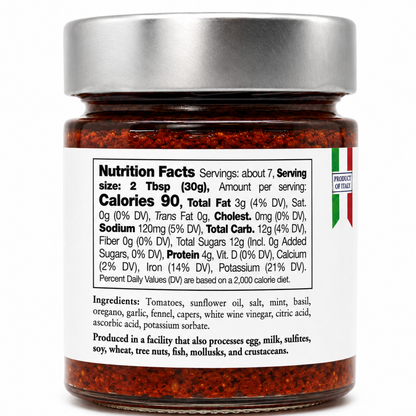 A jar of red pepper flakes with a silver lid and a white nutrition facts label, photographed on a clean white background.