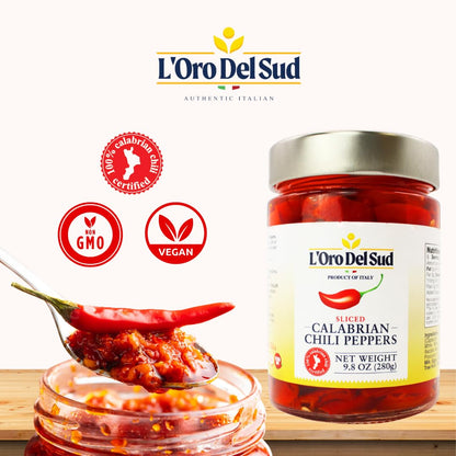 Jar of L'Oro Del Sud Calabrian chili peppers with a spoonful of chili paste on a white background.