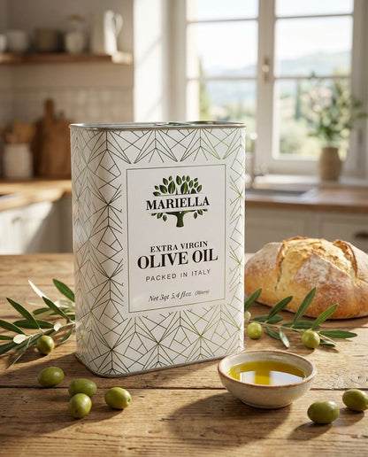 Can of Mariella extra virgin olive oil on a wooden table with bread and olives.