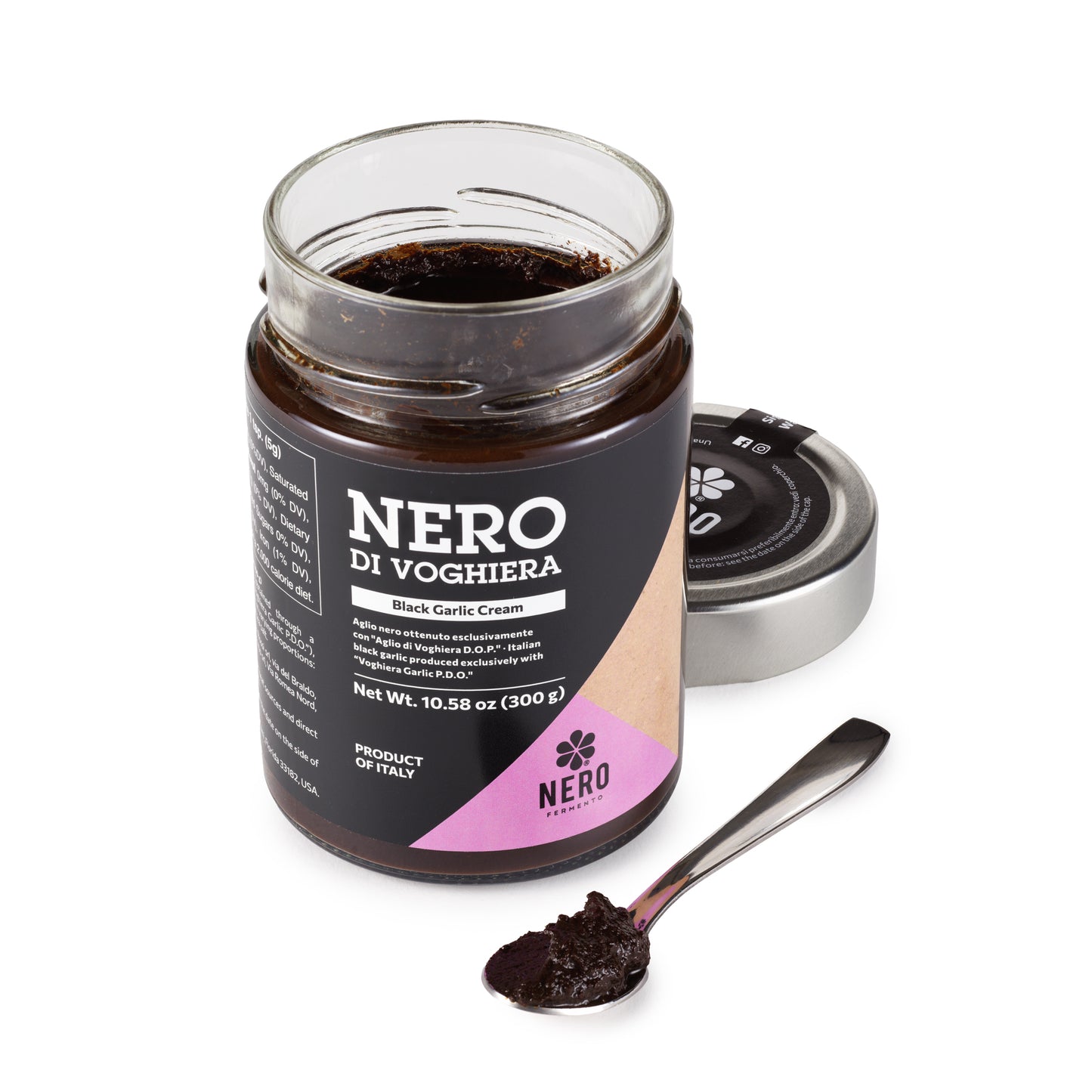 Jar of Nero di Voghiera black garlic cream with a spoonful of cream on a white background
